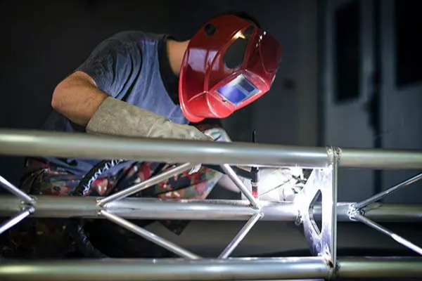 TIG welder working on a metal fabrication project